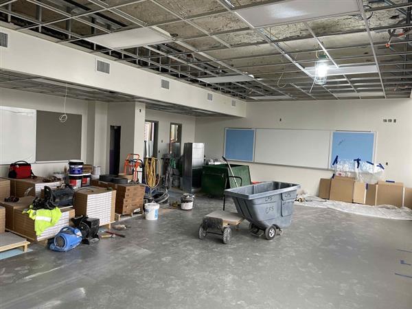 Painted classroom and installation of ceiling grid, flooring, and AV boards on fourth floor 